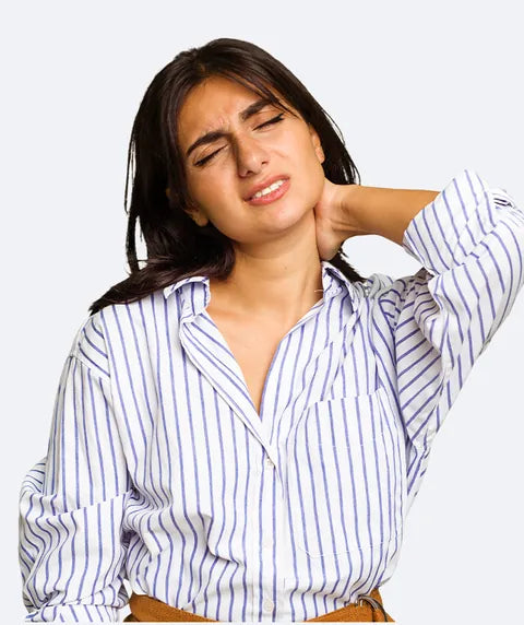 A woman wincing, her hand on the back of her neck
