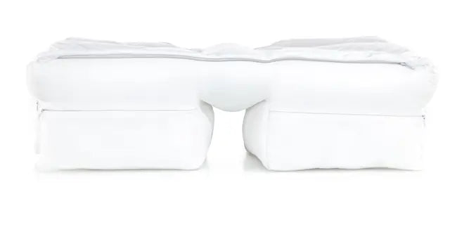 A side sleeper on the Wife Pillow, the bottom arm through the arm tunnel