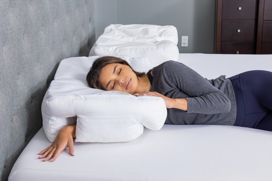 A woman asleep on her side on the Wife Pillow in a bedroom