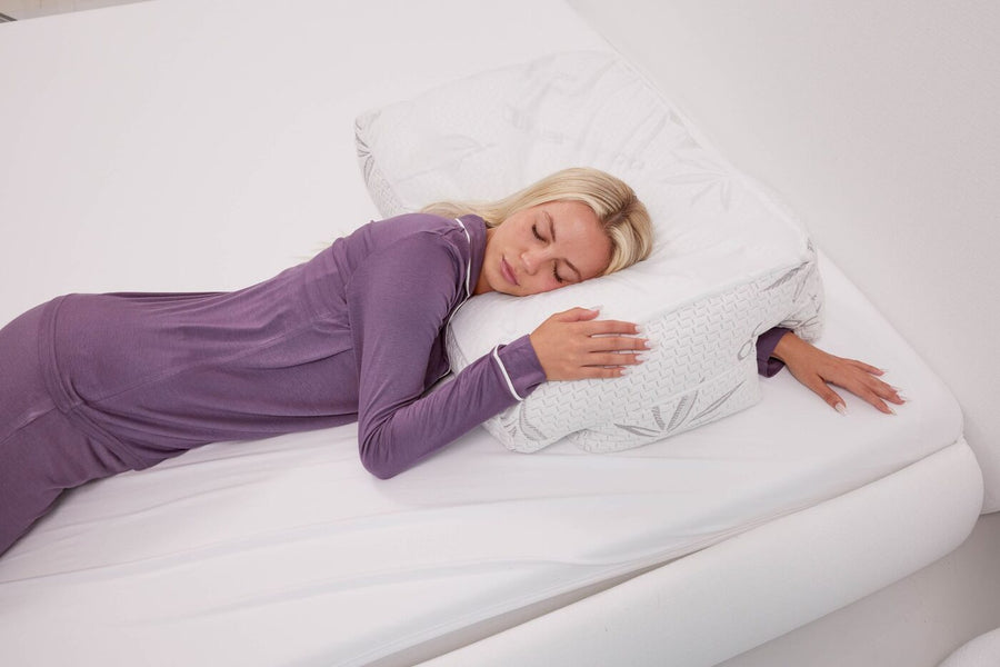 A side sleeper on the Wife Pillow in a bedroom